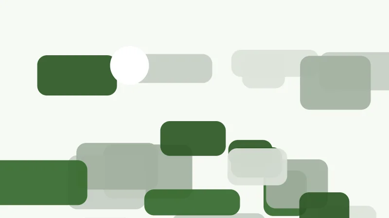 Rounded green blocks scattered across a pale ground